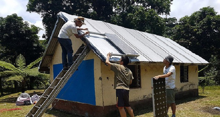 students installing solar panels in Vanuatu