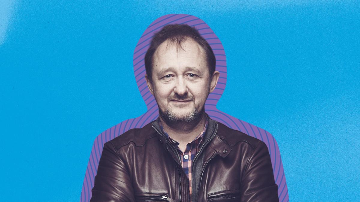 Andrew Upton against a blue background