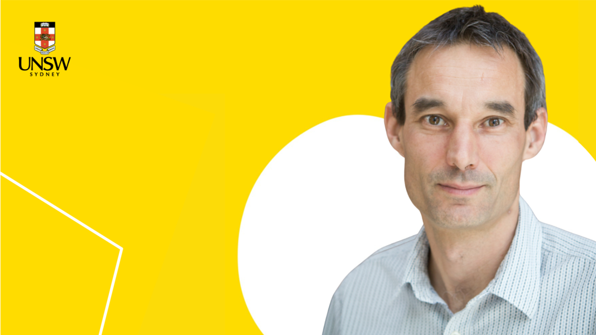A man against a yellow background