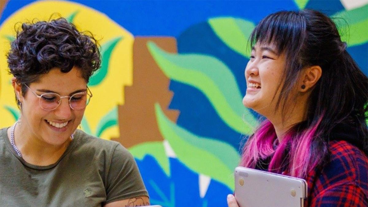 Two students against a bright background
