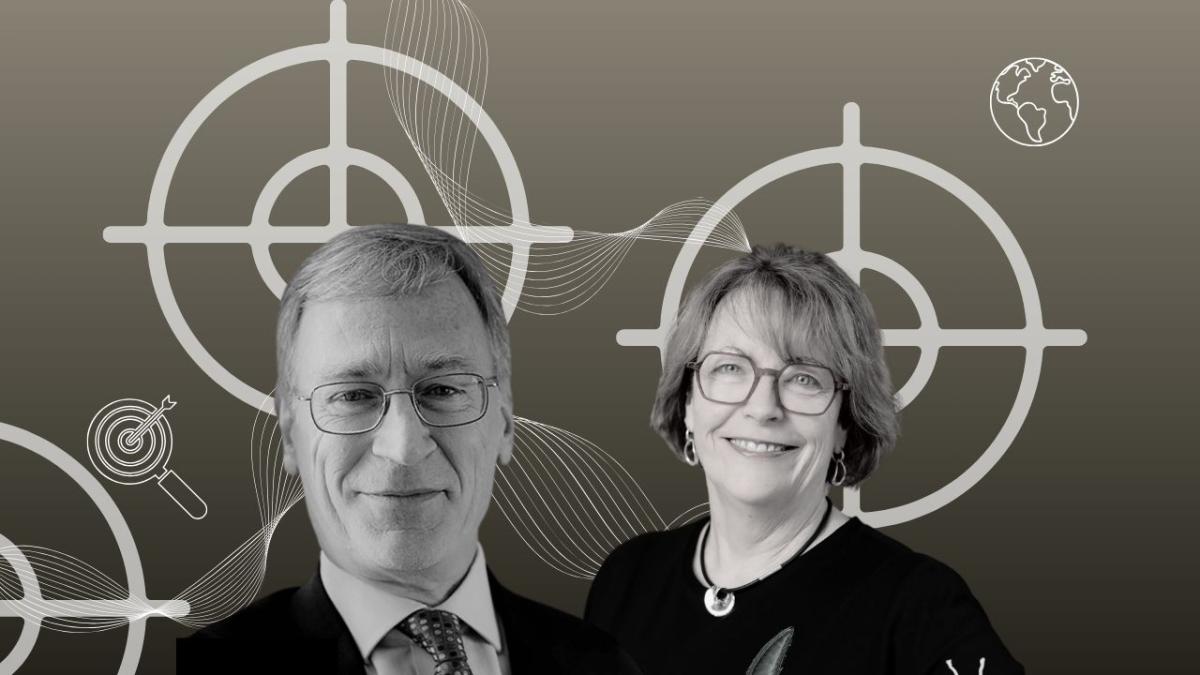 A man and woman in black and white against targets