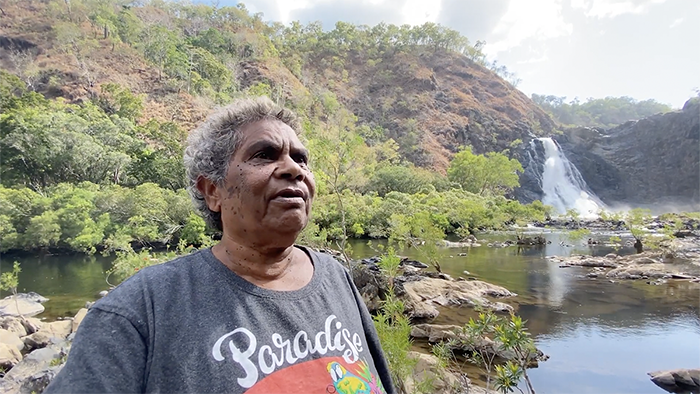 A man standing by a river
