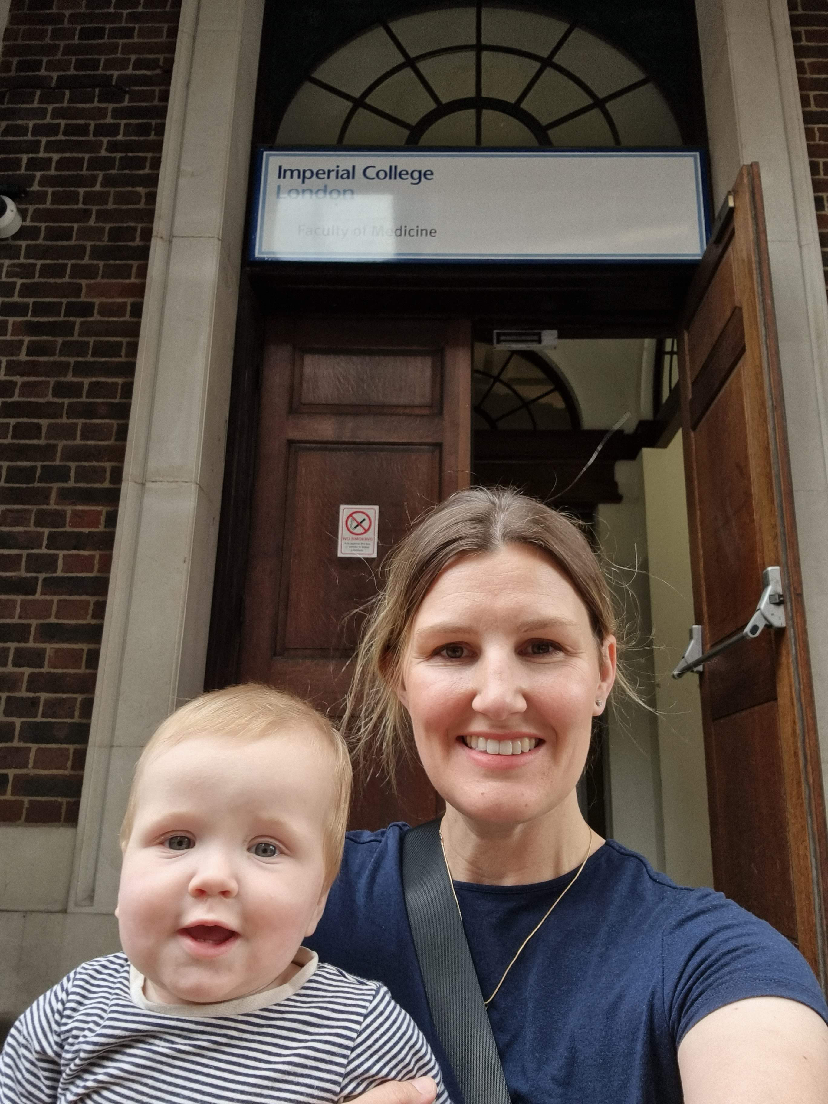 Woman and child stand before Imperial College London building