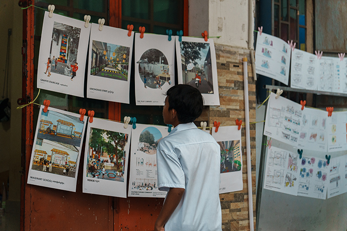 A child looking at images pegged to a line