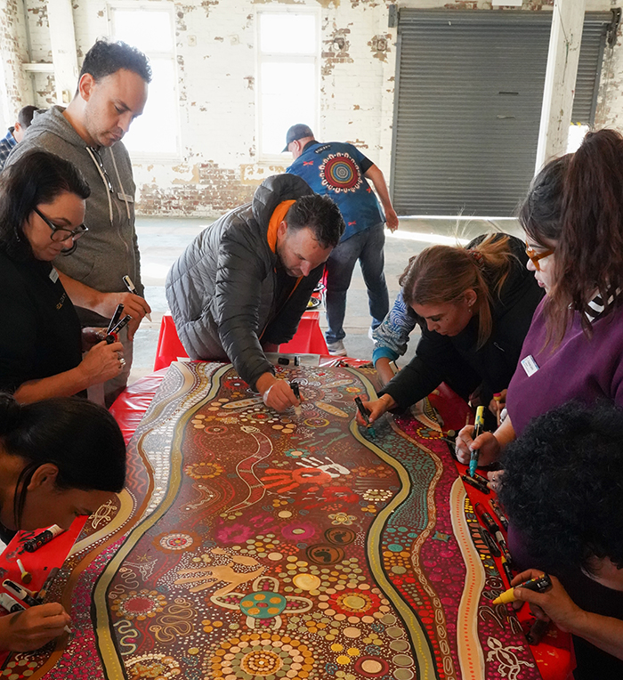 Members of the 10th EILP cohort working together on an artwork