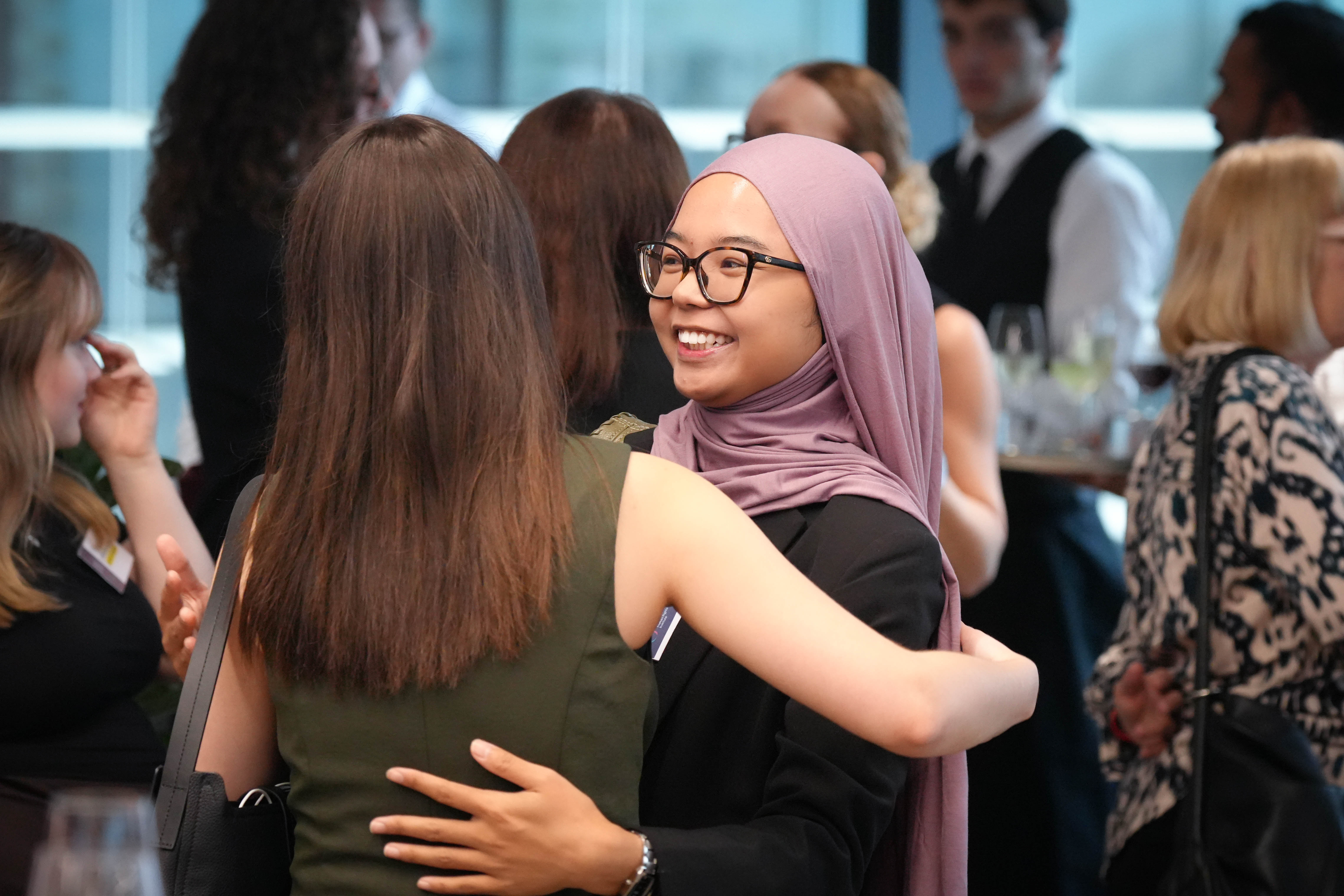 A student hugging a friend