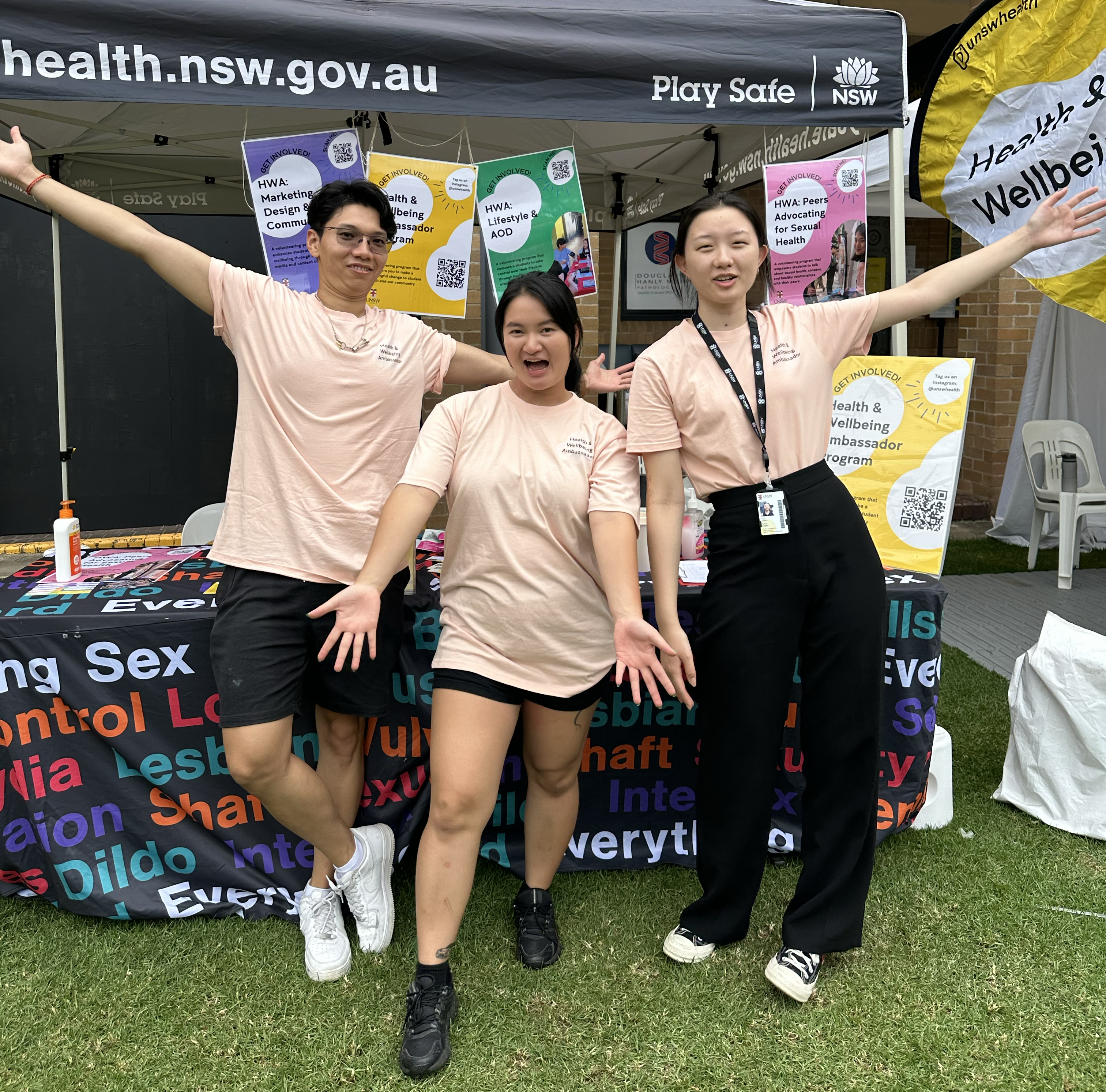 Three UNSW students standing at a market stall