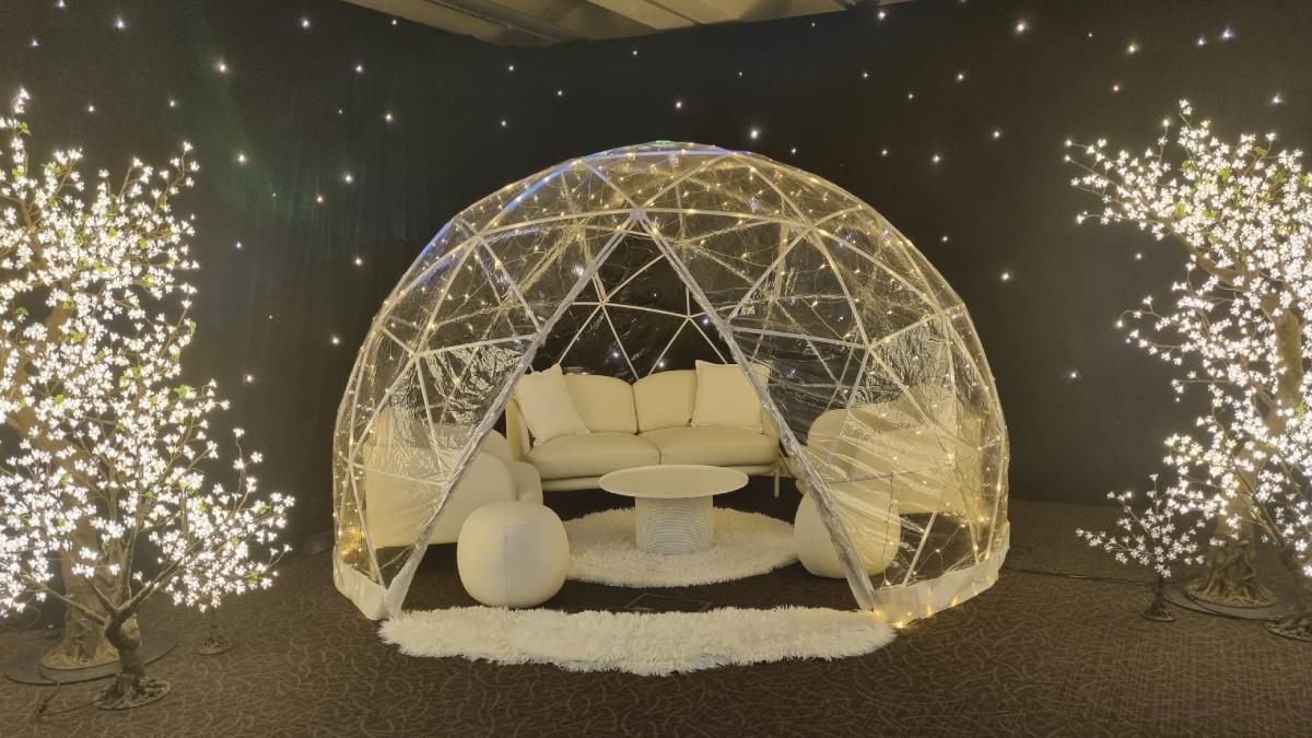 a dome tent inside a black room