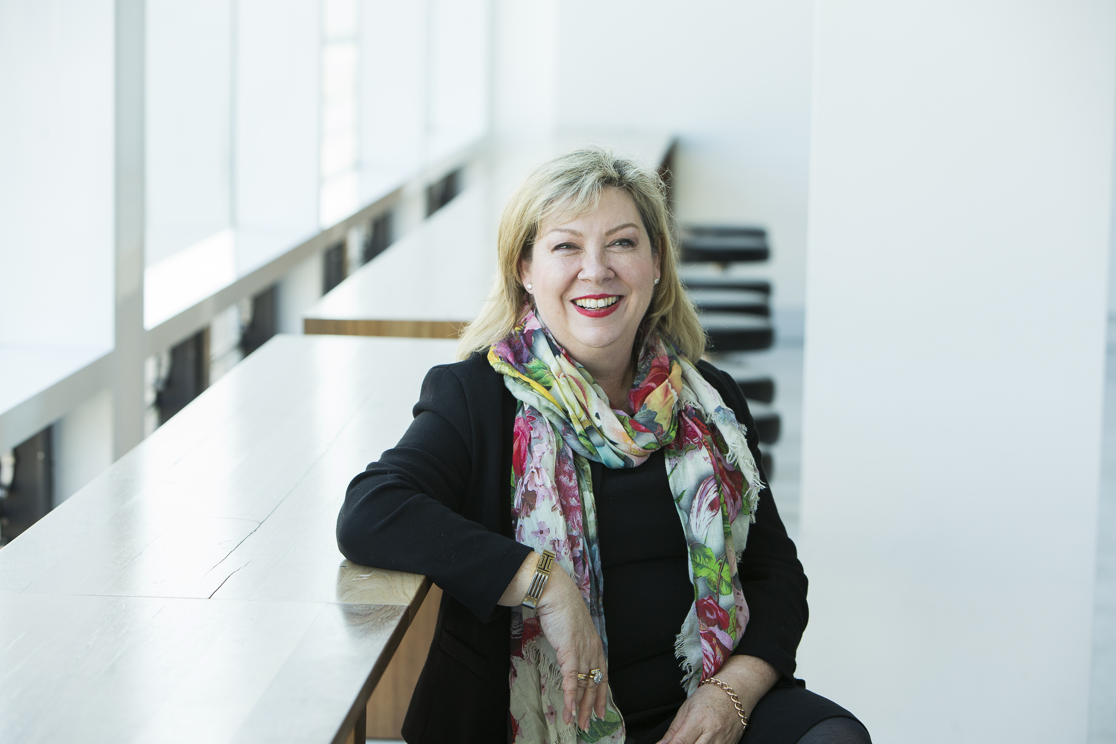 Lynn Gribble sitting at a desk in a classroom.