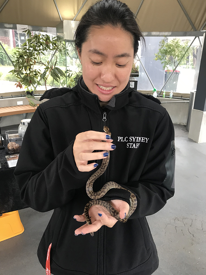Naomi Huynh with a small snake