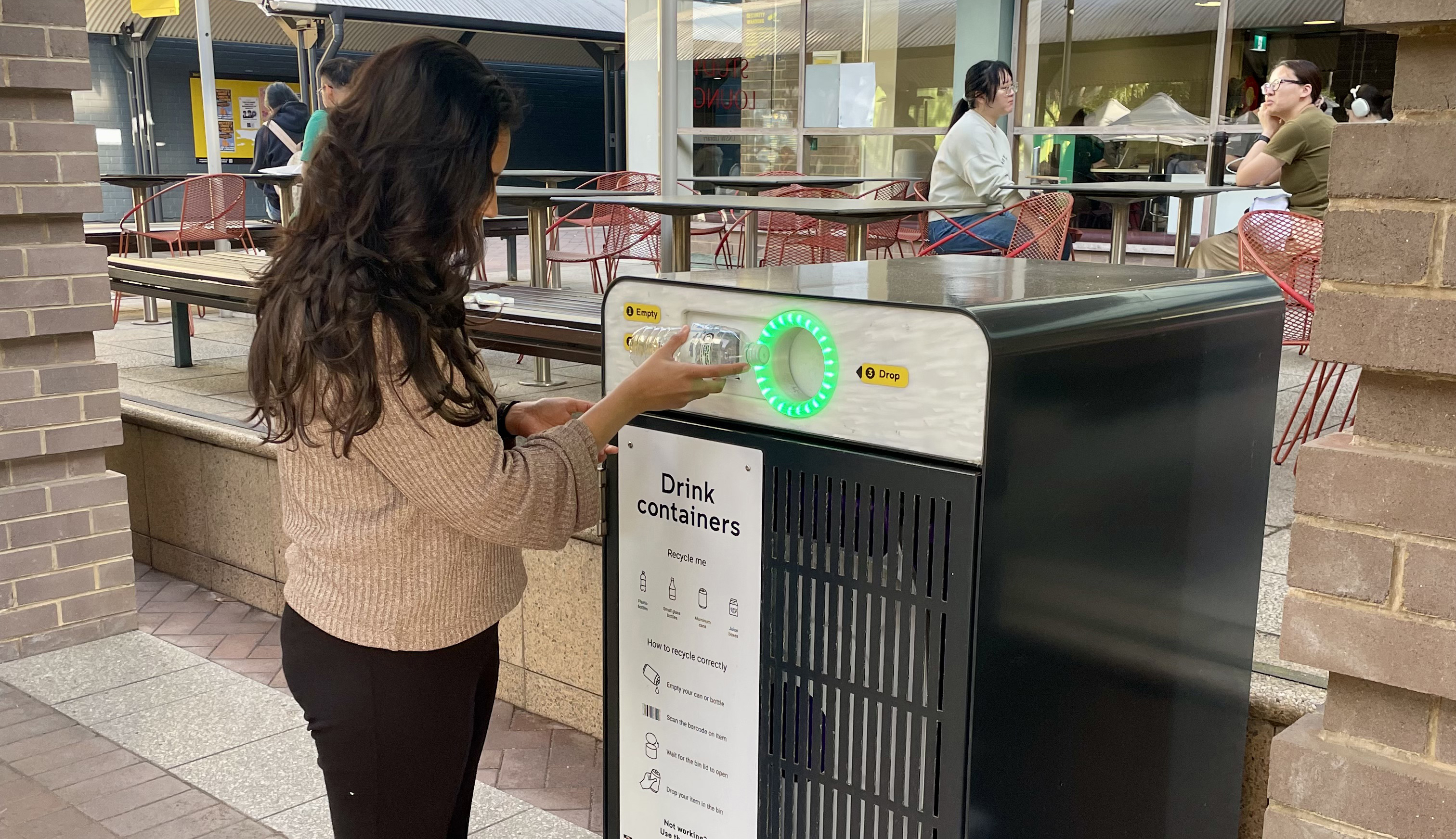 A woman using a smart bin