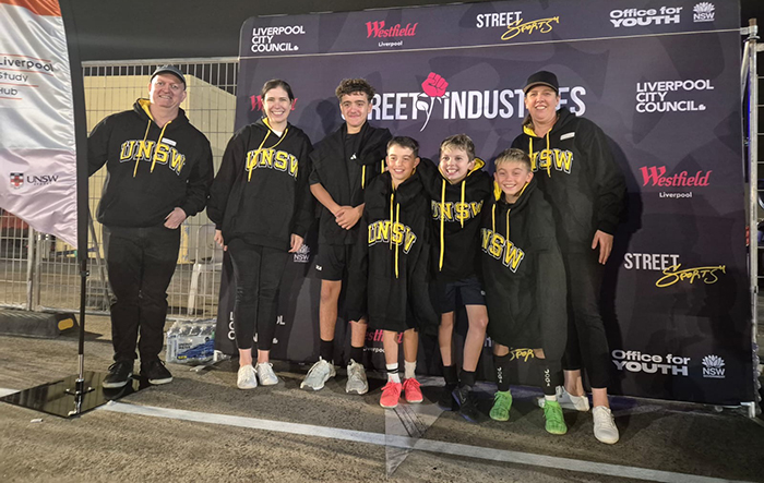 Group of people in front of a Street Industries banner