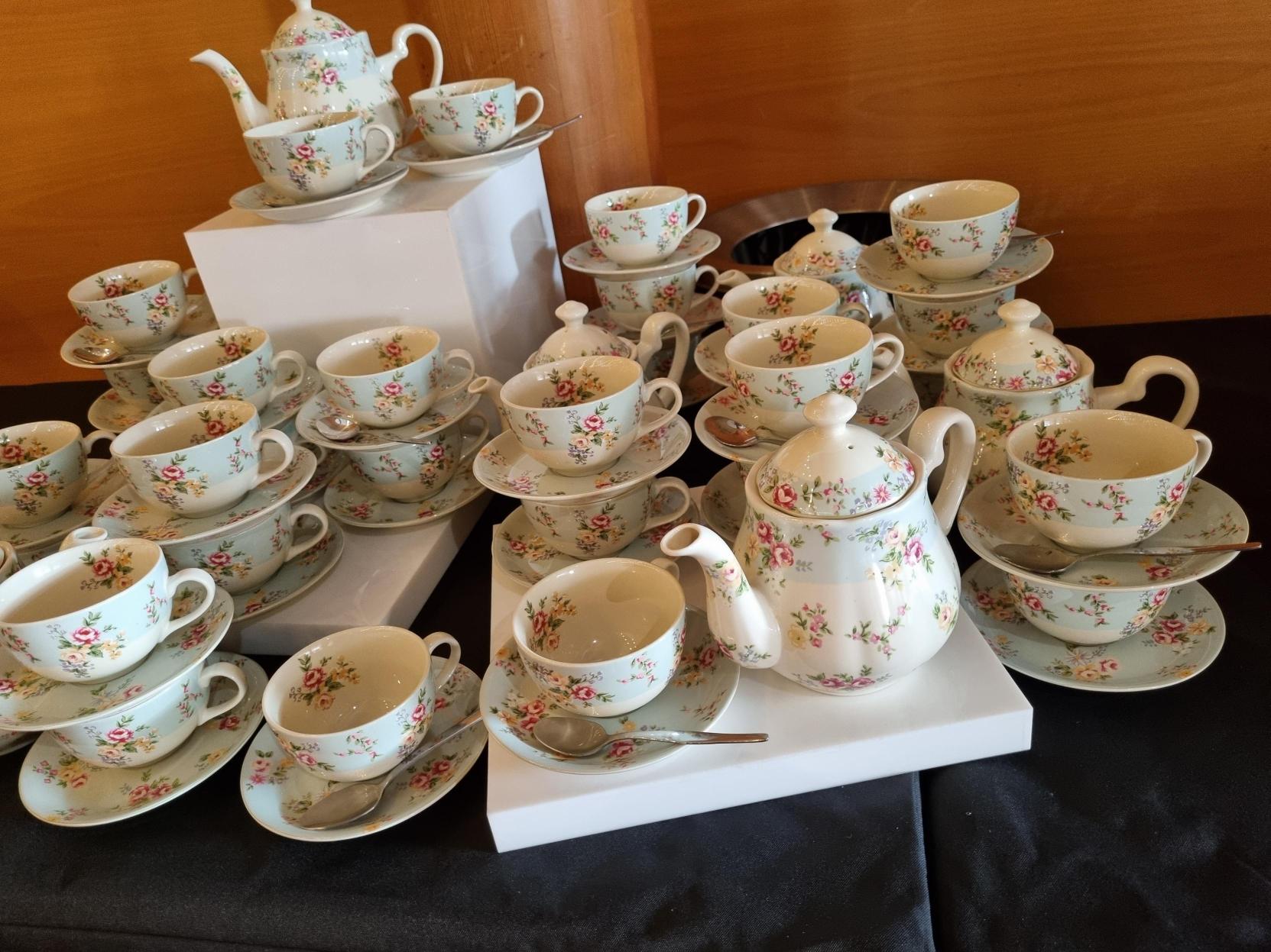 Floral tea pots and cups on a table