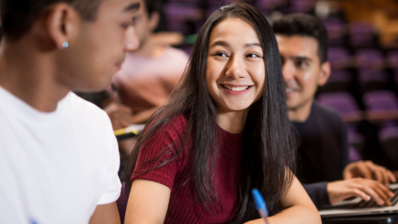 A student in class looking at a peer