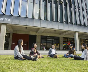 students sitting on grass