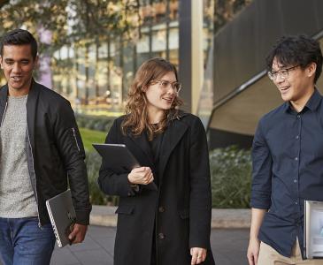 Three students walking and talking