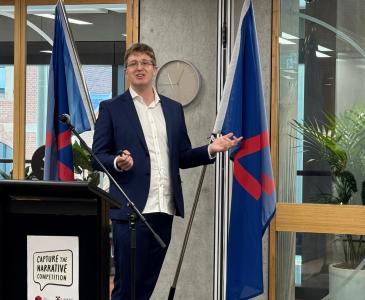 Dr Hammond Pearce presenting at a lectern