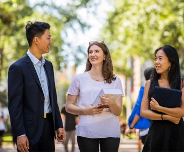 Three students walking and talking