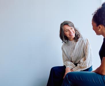 Two women smiling and talking