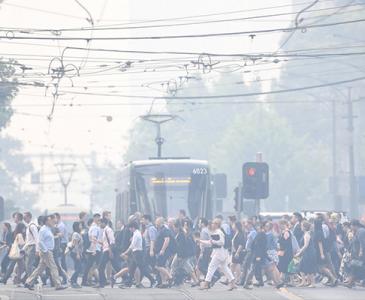 People walking across tram