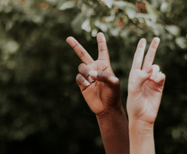 Two hands with peace sign