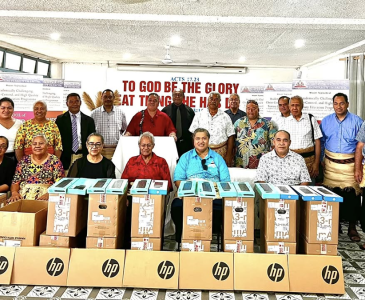 Christ’s University in Pacific staff in Tonga with computer equipment donated by UNSW