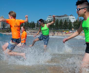 Students running in the ocean