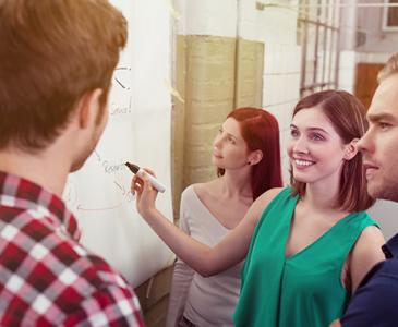 staff at a whiteboard