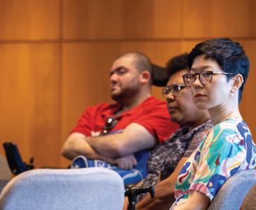 Three university staff members at a round table. 