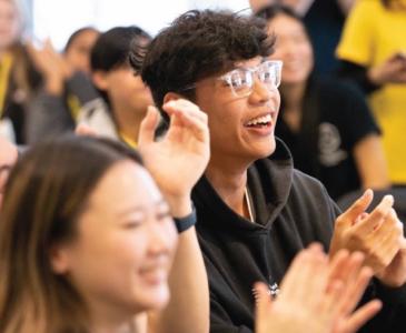 Student clapping and cheering at an event