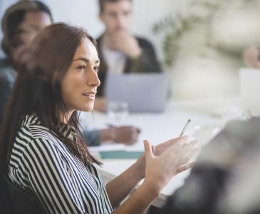 Woman sitting in a corporate meeting