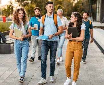 A group of students walk along a path outside