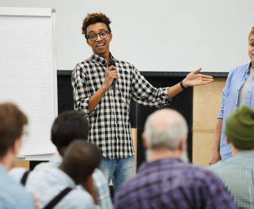 Two people presenting to an audience