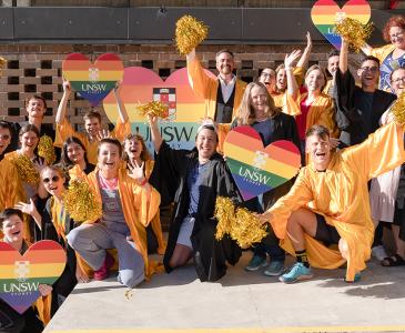 Students and the VC waving rainbow flags