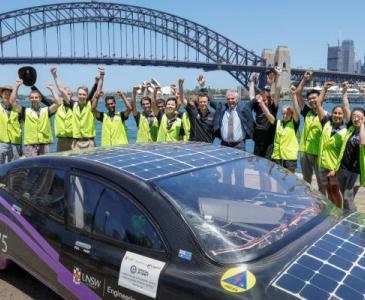 solar car next to Sydney harbour bridge