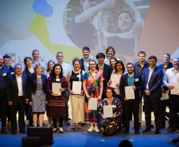 Group shot of people holding awards and smiling
