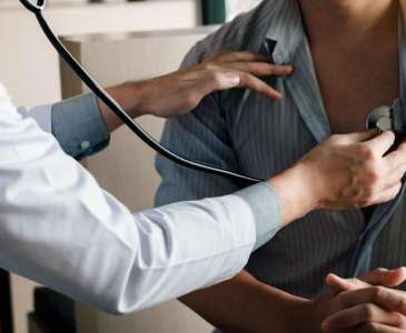 Doctor listening to a patient's heartbeat 