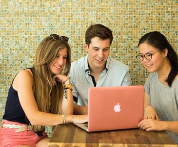 UNSW students gathered around a laptop