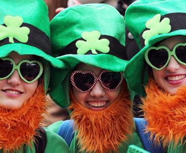 Three people enjoying Saint Patrick's Day celebrations 