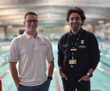 Mark Bull and Mehdi Aardin standing in front of a swimming pool. 