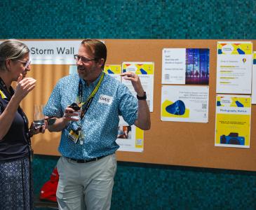 Two staff members talking in the Teaching Commons