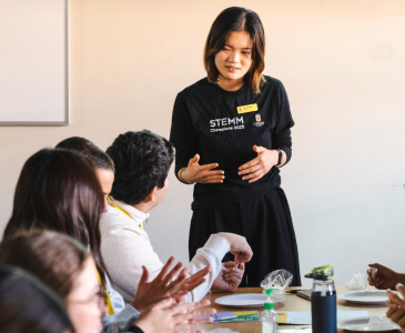 A Stemm staff talking in front of a classroom.