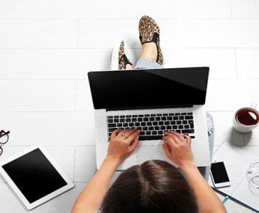 student typing on a laptop