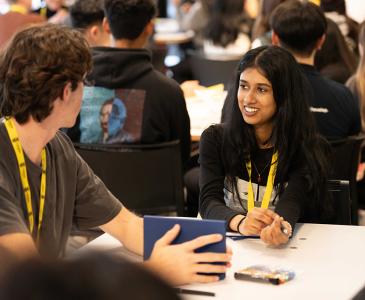 Students at a table in a busy room