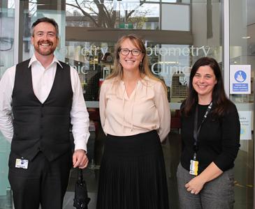 VC standing with two staff at the Optometry school