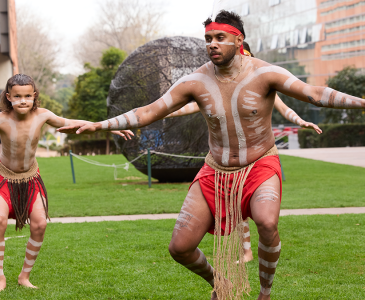 Smoking ceremony performers on Globe Lawn during NAIDOC Week