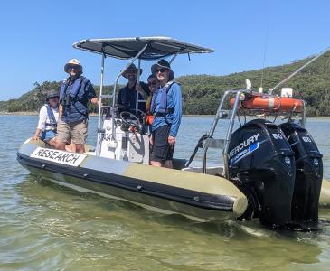 UNSW staff on a boat at Smiths Lake Field Station