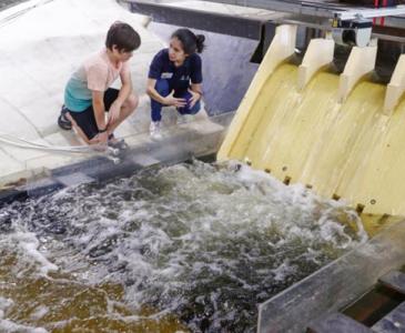 researcher at the Water Research Lab showing a child the facilities