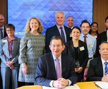 Ian Jacobs and Myint Thien (both seated) at the signing of the MOU