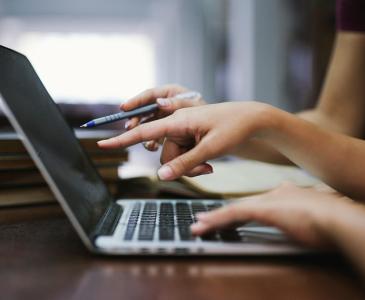 Close up of hands over a laptop